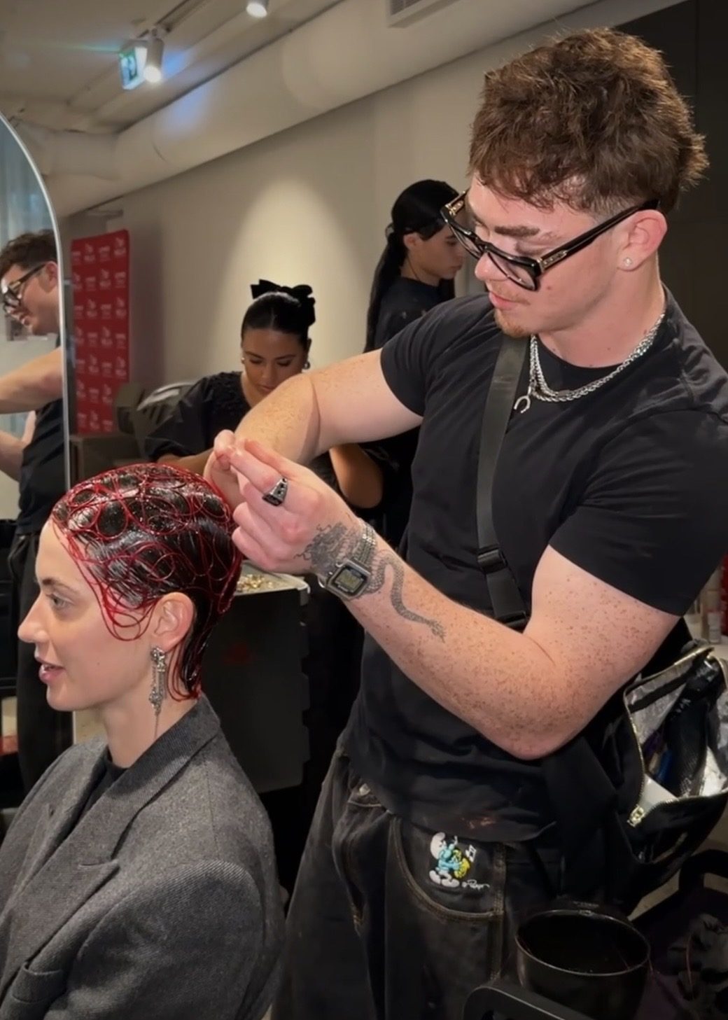 Benny styling a client with red colour
